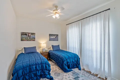 a bedroom with furniture and a chandelier