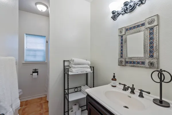 a bathroom with a sink vanity and a mirror