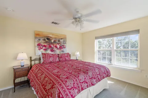 a bedroom with a bed and a painting on the wall