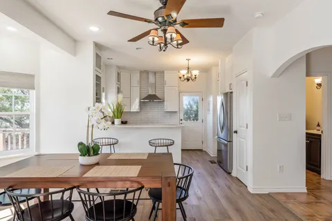 a view of a dining room with furniture and a chandelier