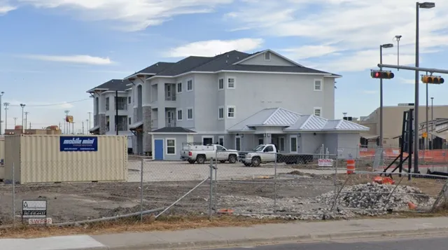 a front view of a building with many windows