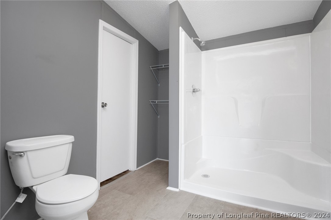 152 Three Bridges Road Rowland, NC 28383 - Photo 15 of 27 a white toilet sitting next to a bath tub