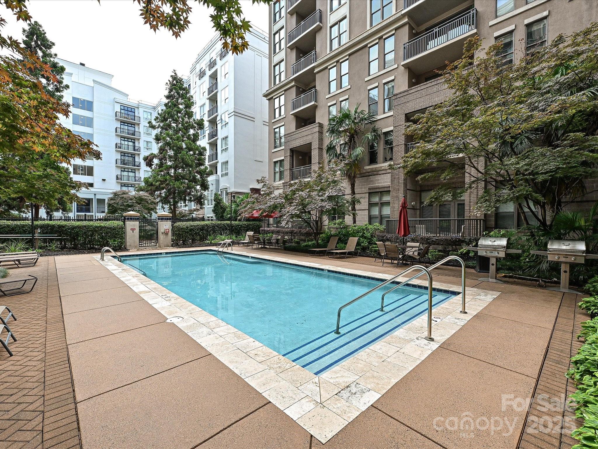 718 West Trade Street Charlotte, NC 28202 - Photo 22 of 24 a view of swimming pool with outdoor seating and a buildings