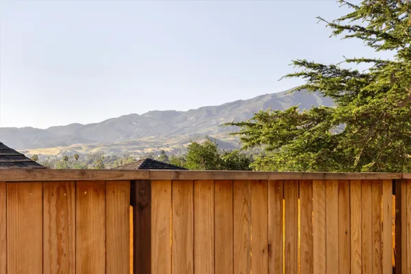 a view of balcony with wooden fence