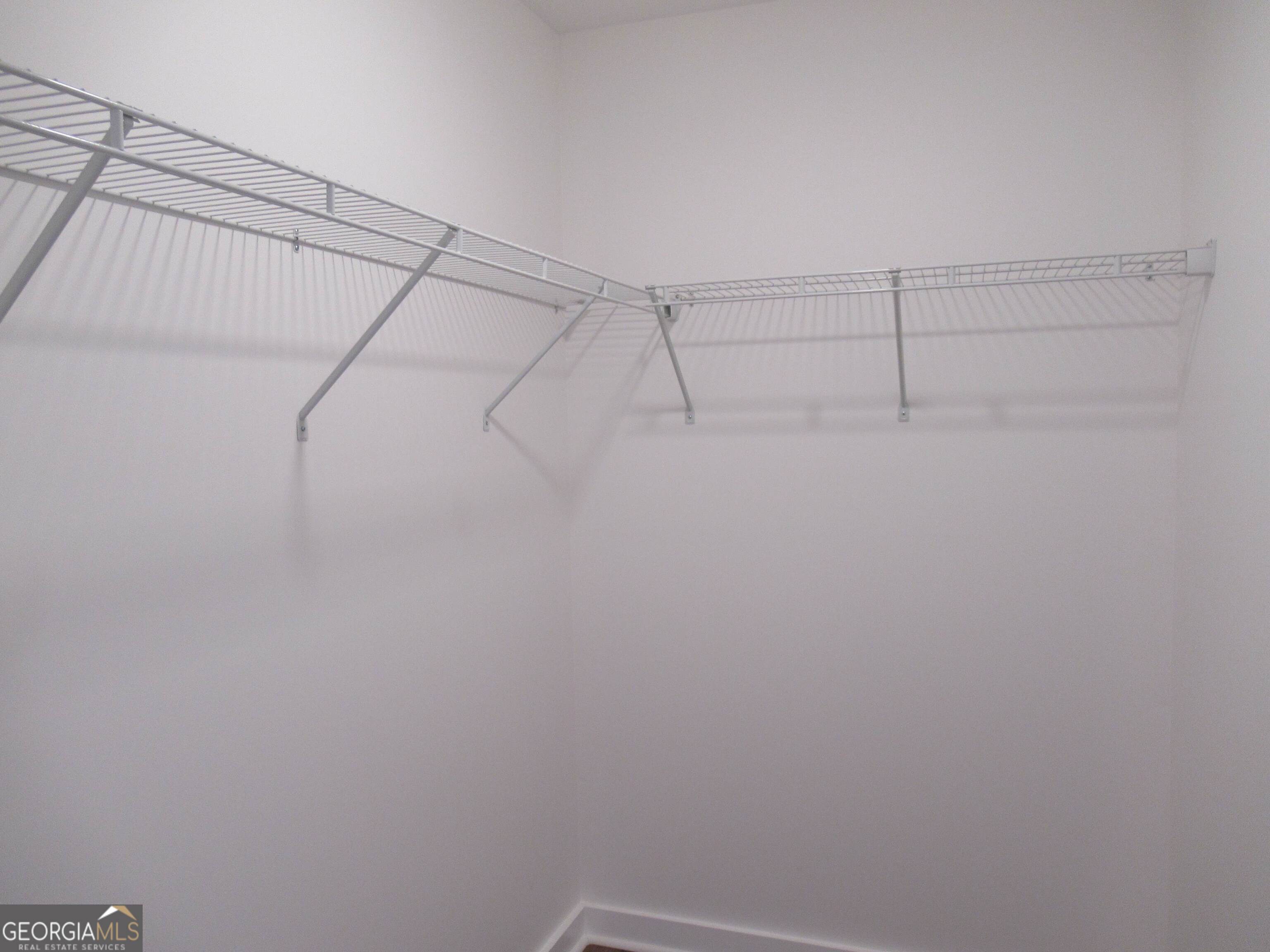 765 Old Kerns Road Dawsonville, GA 30534 - Photo 24 of 36 a view of a room with racks on the wall
