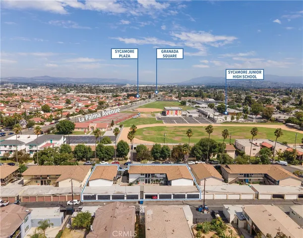 an aerial view of residential houses with outdoor space