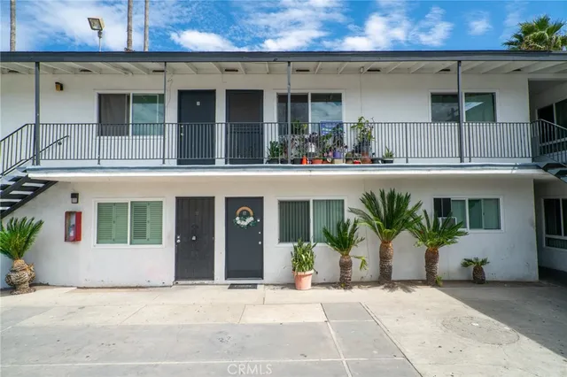 a front view of a house with plants