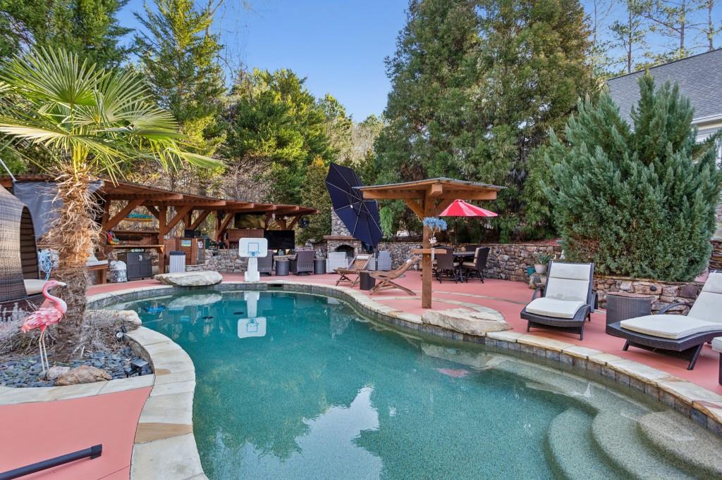 a view of a swimming pool with sitting area