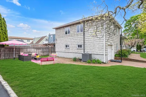 a front view of a house with patio and garden
