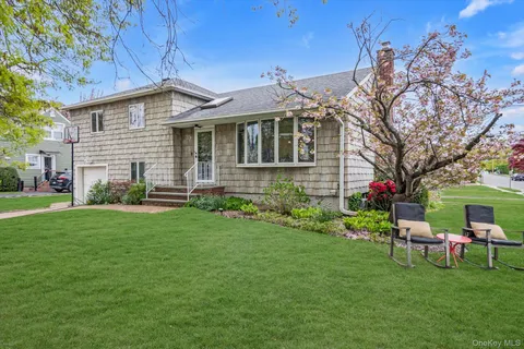 a front view of house with a garden and patio