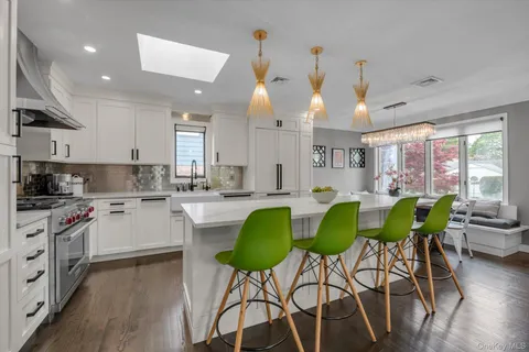 a kitchen with kitchen island granite countertop wooden cabinets and stainless steel appliances