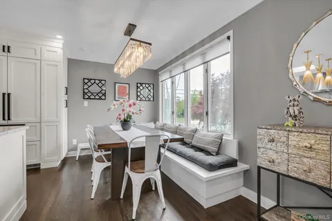 a living room with furniture a wooden floor and a large window