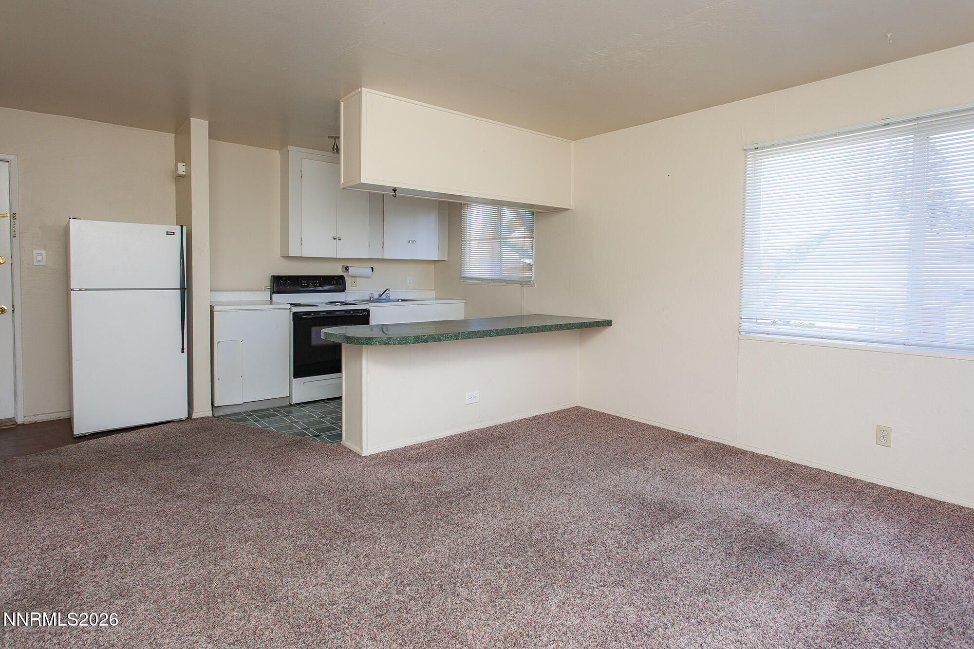 1060 Wilson Avenue Reno, NV 89502 - Photo 7 of 17 a kitchen with stainless steel appliances a sink stove and refrigerator