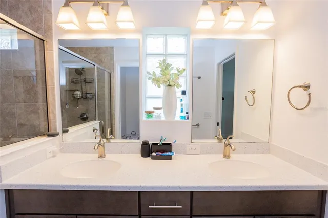a backyard of a house with table and chairs plants and large tree