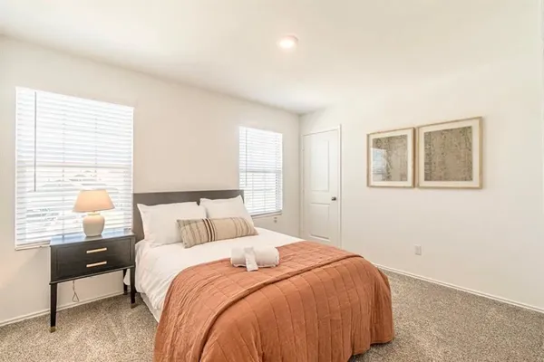 a bedroom with a bed and a night stand
