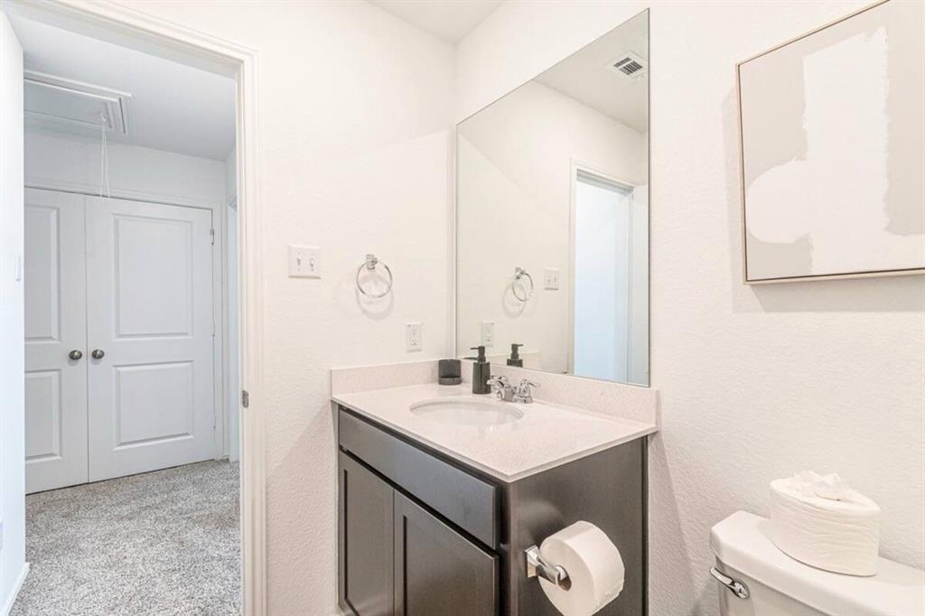 441 Gabbro Gardens Maxwell, TX 78656 - Photo 19 of 22 a bathroom with a sink toilet and vanity