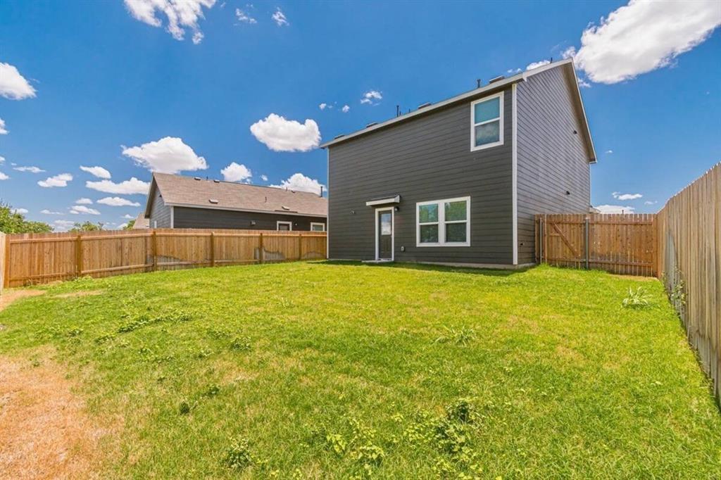 441 Gabbro Gardens Maxwell, TX 78656 - Photo 3 of 22 a front view of a house with a yard