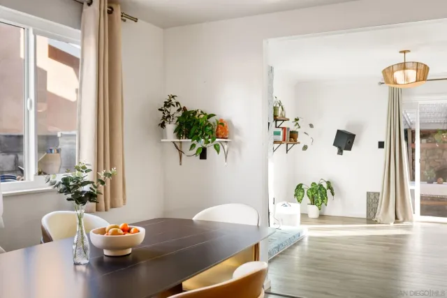 a living room with furniture flowerpot and wooden floor