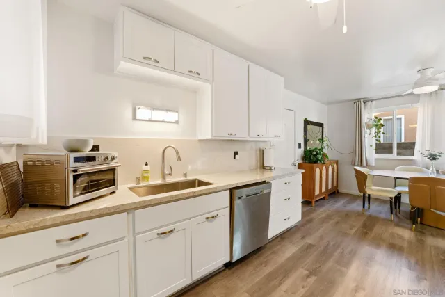 a kitchen with cabinets a sink and appliances