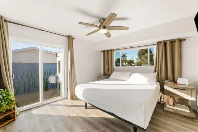 a bedroom with a large bed and a chandelier