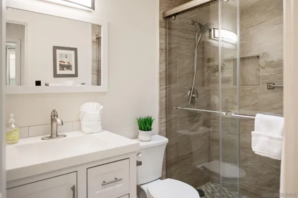 a bathroom with a sink toilet and shower
