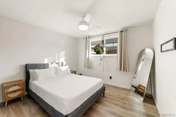 a bedroom with a bed and a large window