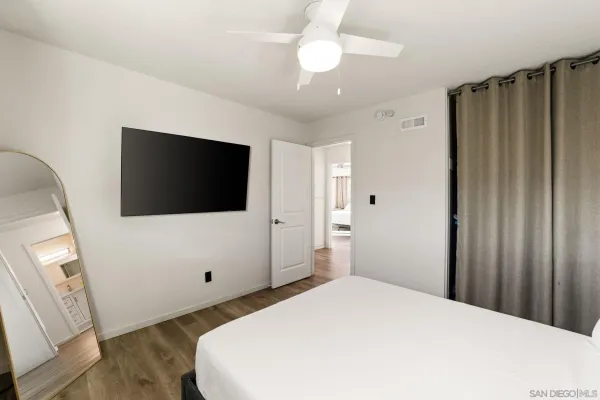 a bedroom with a bed and a flat screen tv