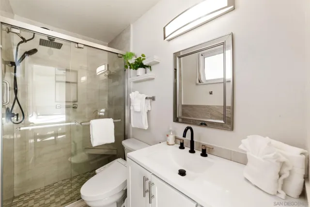 a bathroom with a sink toilet and shower