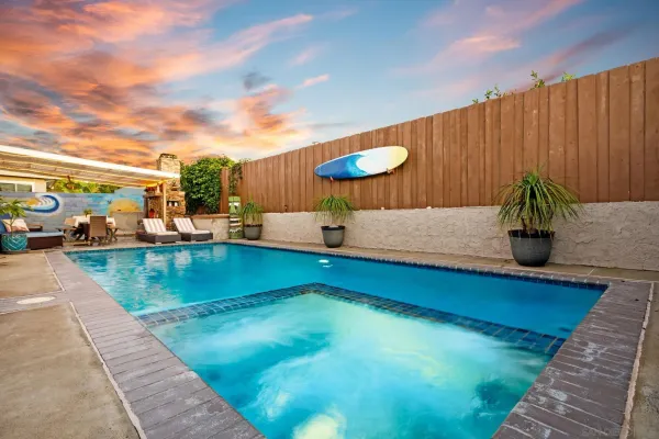 swimming pool view with a garden space