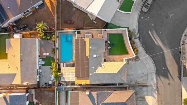 an aerial view of a house with a yard and a fountain