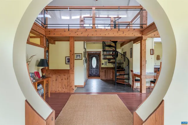 a view of living room with furniture and wooden floor