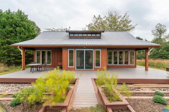 a front view of a house with sitting area and garden