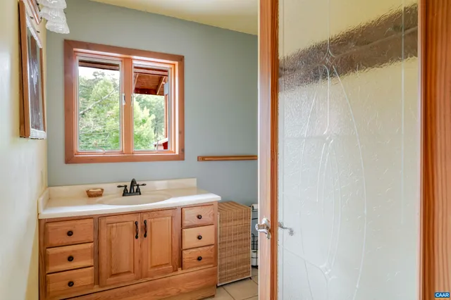 a bathroom with a sink double vanity and a shower