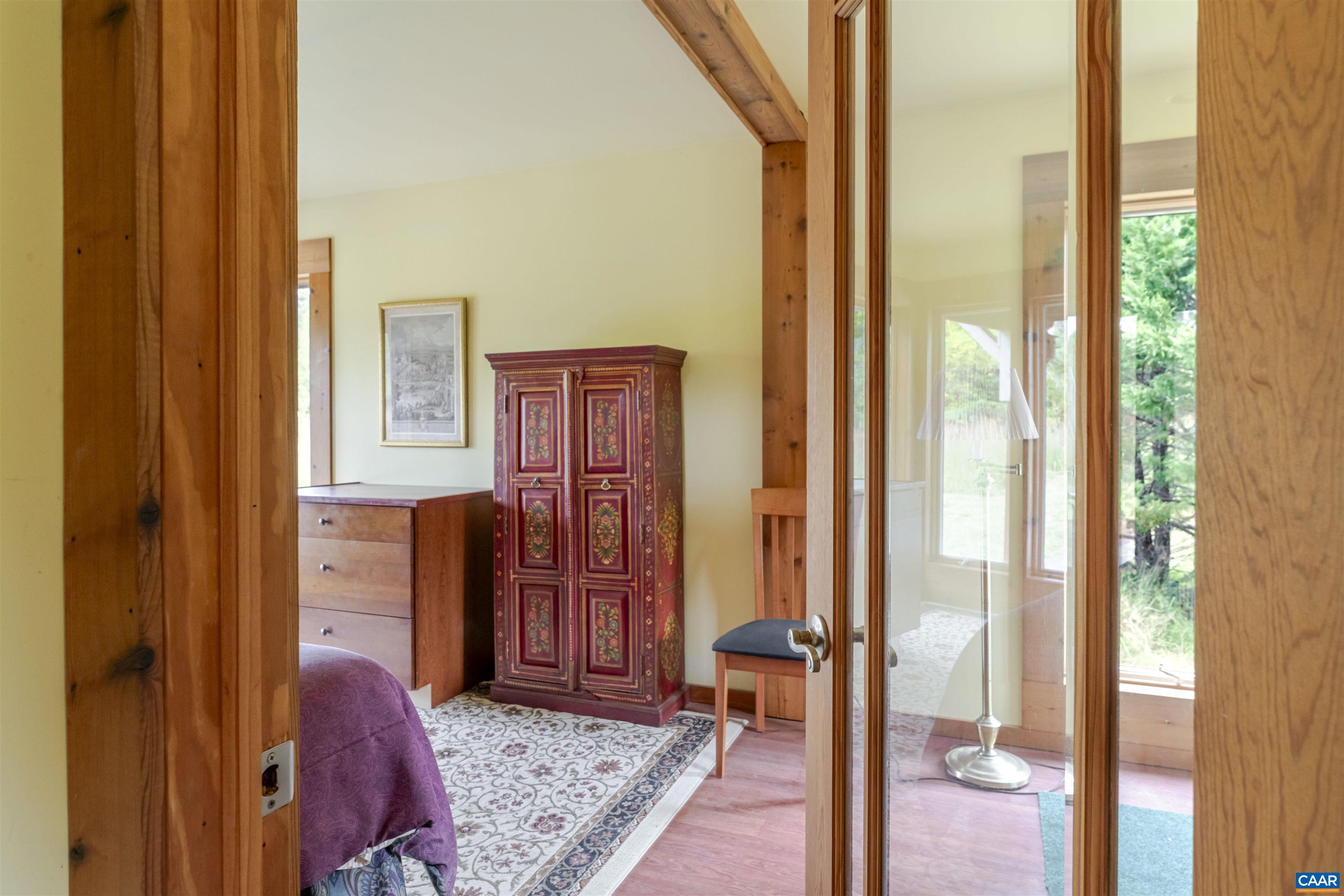 787 Durrett Town Road Afton, VA 22920 - Photo 36 of 49 a bedroom with a bed and a dresser next to a window
