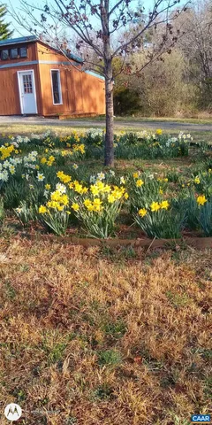 a view of a house with a yard and sitting area