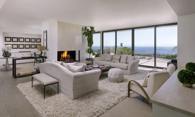 a living room with furniture and a floor to ceiling window