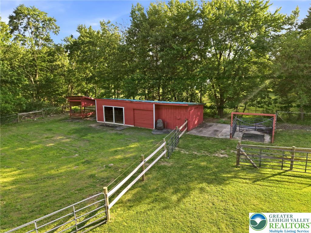 9033 Loop Road Slatington, PA 18080 - Photo 4 of 53 A pastoral expanse offers a red barn, ample yard space, and secure fencing.