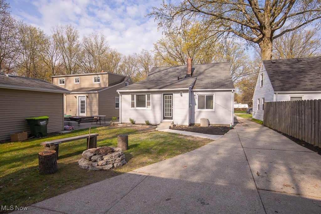 223 Beck Road Avon Lake, OH 44012 - Photo 25 of 29 View of back of house with fence, a fire pit, a chimney, and a front yard
