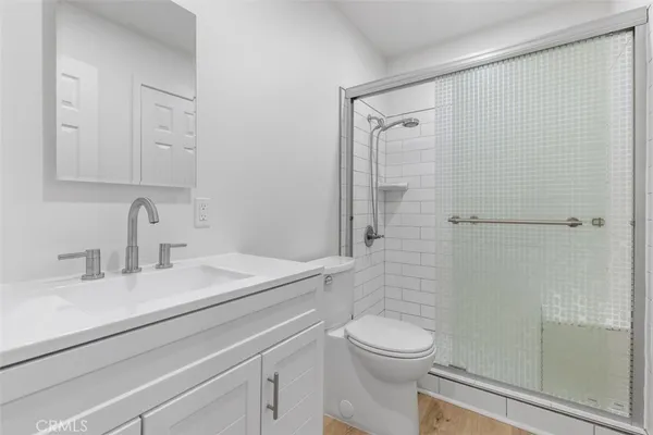 a bathroom with a granite countertop sink toilet and shower