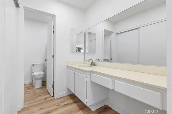 a spacious bathroom with a granite countertop sink toilet and shower