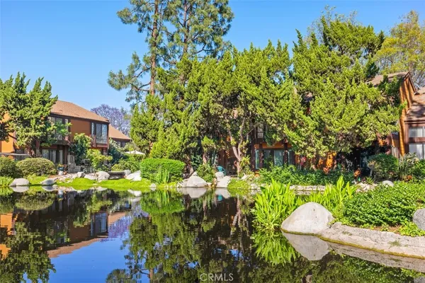 a backyard of a house with a yard and outdoor seating