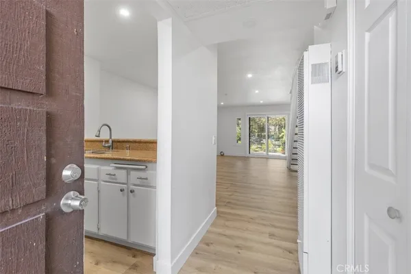 a view of hallway with wooden floor