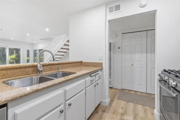 a kitchen with a sink and cabinets