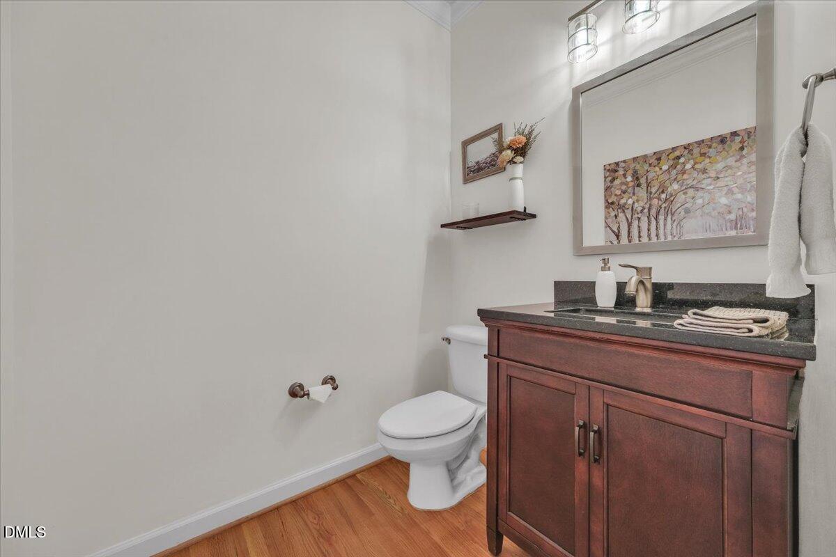 2908 Oak Bridge Drive Raleigh, NC 27610 - Photo 22 of 47 a bathroom with a toilet a sink and mirror