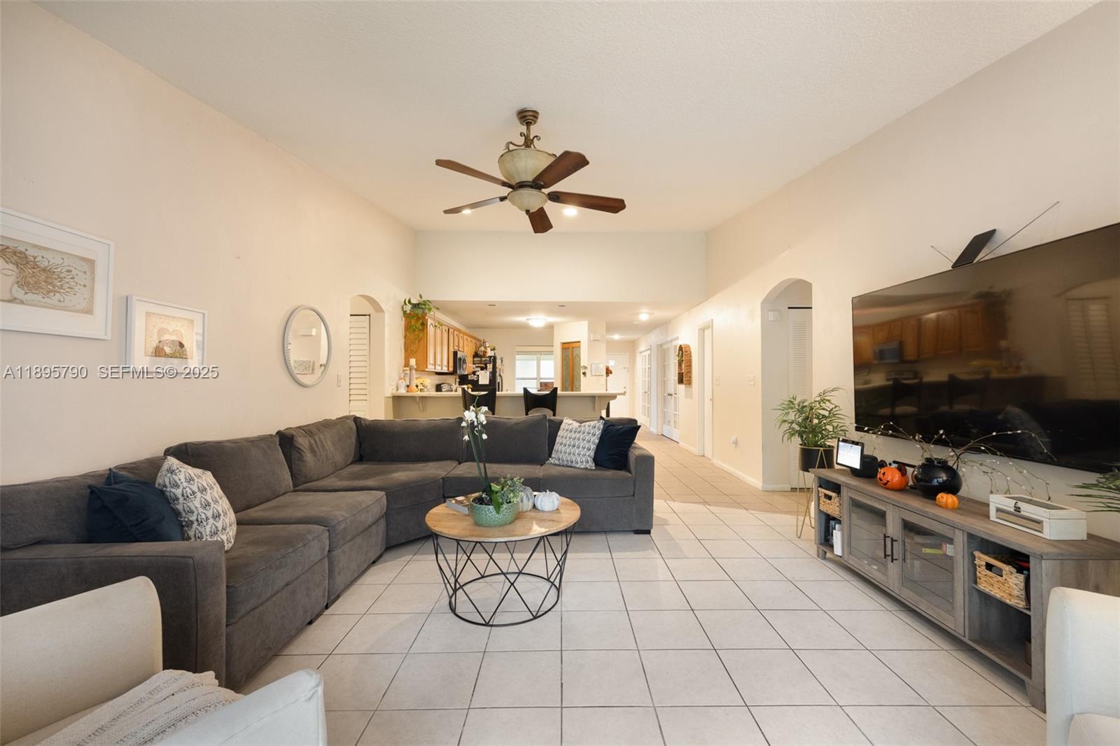 9730 Southwest 219th Street Cutler Bay, FL 33190 - Photo 12 of 25 a living room with furniture and a flat screen tv