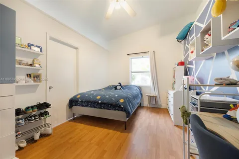 a bedroom with a bed and a tv