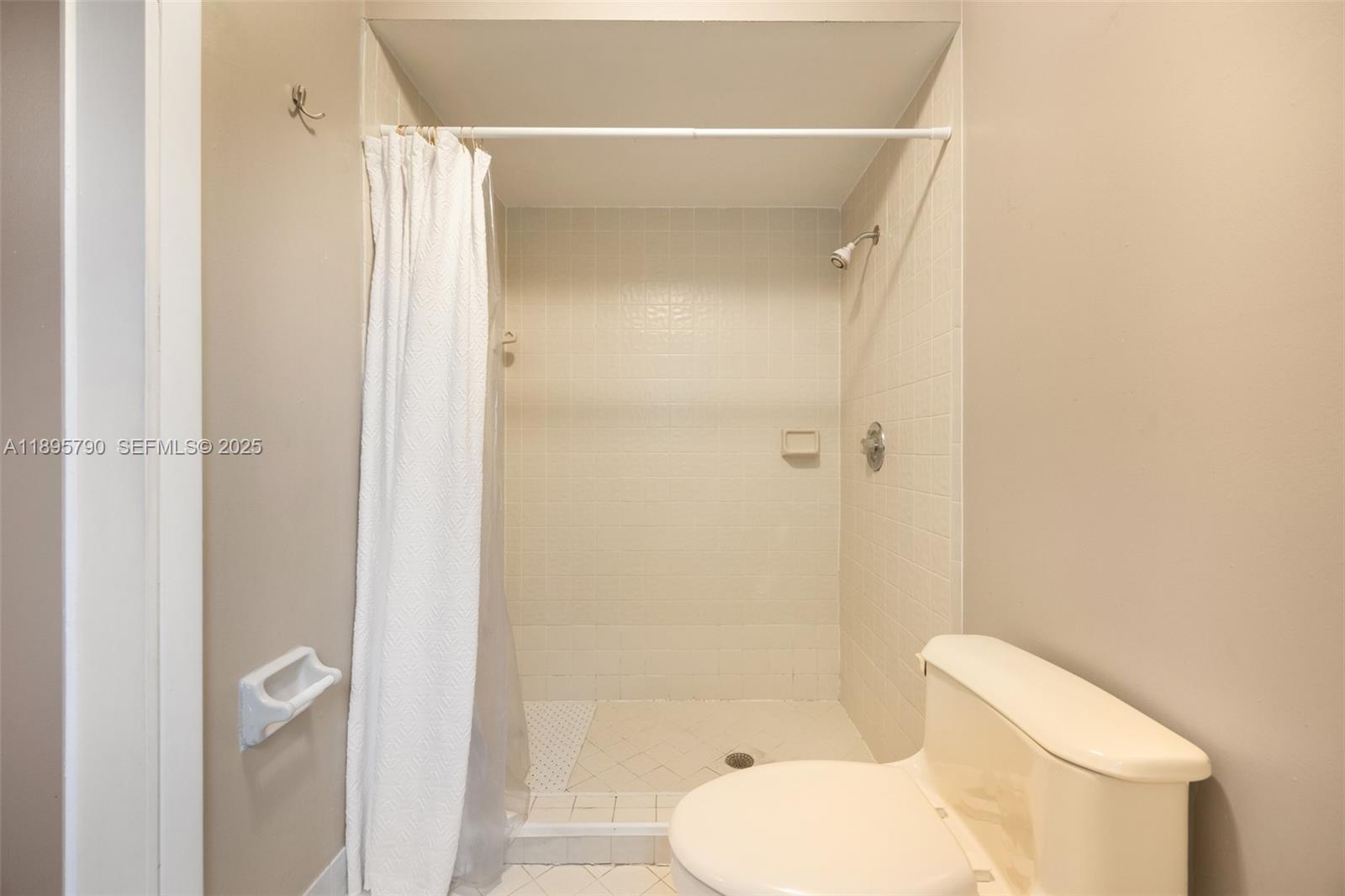 9730 Southwest 219th Street Cutler Bay, FL 33190 - Photo 20 of 25 a bathroom with a toilet and a shower