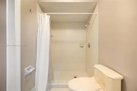 a bathroom with a toilet and a shower