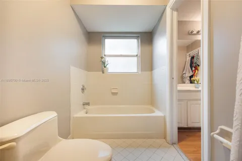 a bathroom with a toilet bathtub and window