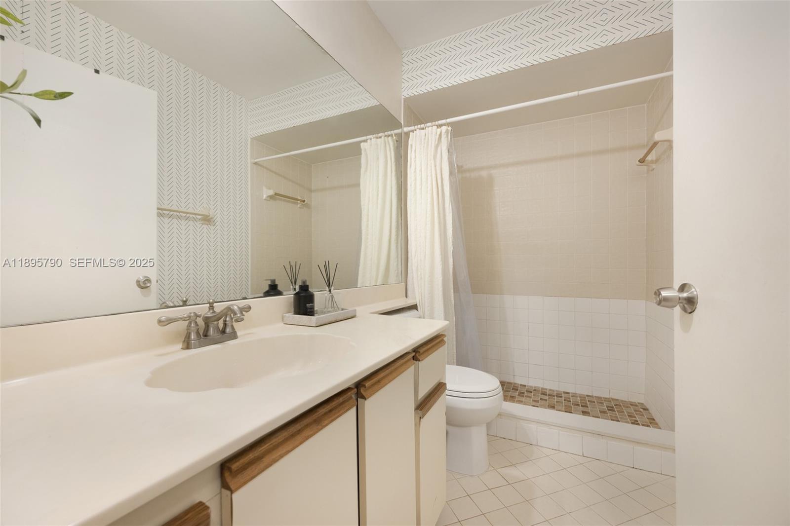 9730 Southwest 219th Street Cutler Bay, FL 33190 - Photo 23 of 25 a bathroom with a sink a toilet and shower